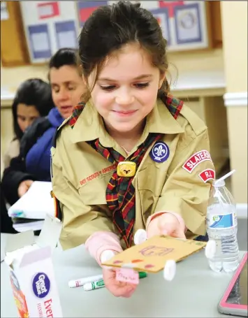  ?? Ernest A Brown photo ?? Maddie Silva, 9, proudly works on her Pinewood Derby car at Tuesday’s meeting of members of Pack 7 Slaterslvi­lle Cub Scouts, who gathered at Scouters Hall in North Smithfield.