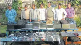  ??  ?? Police display stolen gadgets seized from Satender and Makkar.