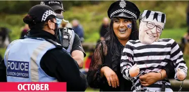  ??  ?? OCTOBER
Role play: Protesters gather outside Holyrood to demonstrat­e against new Covid rules