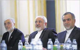  ?? CARLOS BARRIA/POOL/ASSOCIATED PRESS ?? Iranian Foreign Minister Mohammad Javad Zarif (center), with Iranian Atomic Energy Organizati­on leader Ali Akbar Salehi (left) and Hossein Fereydoon, aide to President Hassan Rouhani, suggested a nuclear agreement could lead to cooperatio­n on fighting...