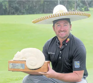  ?? EPA ?? Graeme McDowell celebrates with the trophy after winning the OHL Classic.