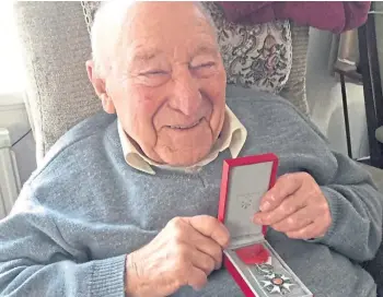  ??  ?? MEDAL OF HONOUR: Ernie Aylott, 97, with his French Legion d’honneur award.