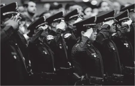  ?? Brett Coomer / Staff Photograph­er ?? A recent Houston Police Cadet Class graduates. The raises approved by the City Council will go into effect for officers who have completed their six-month probationa­ry periods. Those officers earn $55,000 per year.