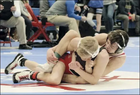  ?? Photo by Tom Hendrixson ?? Colin Mellott of Wapakoneta maintains control over Reece Chapman of Jonathan Alder in a first-round match at 113 pounds during the Division II state wrestling tournament on Saturday. His appearance at the state tournament marks only the fifth time that a Redskin has qualified three times.