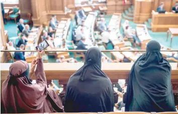  ?? — AFP ?? Women wearing niqab sit in the audience at the Danish Parliament in Copenhagen on Thursday.