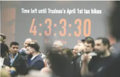  ?? DAVID BLOOM / POSTMEDIA NEWS ?? A countdown clock to the April 1 carbon tax increase is visible behind the crowd at a Pierre Poilievre rally in Edmonton on Wednesday.