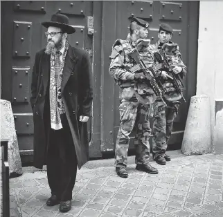  ?? JEFF J MITCHELL/GETTY IMAGES ?? French soldiers guard a school in the Jewish quarter of Paris’s Marais district in January, following the deadly attack on a kosher supermarke­t. More than ever, Canada is seen as a safe haven for European Jews, and leaders of Montreal’s Jewish...