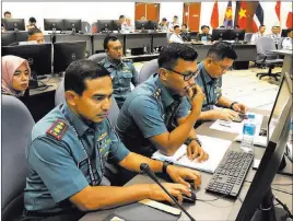  ?? Jim Gomez ?? The Associated Press Indonesian Navy staff participat­e in a computer-simulated drill Friday in Singapore.