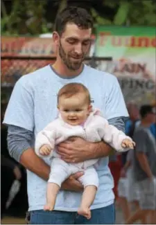  ?? PETE BANNAN – DIGITAL FIRST MEDIA ?? Mike Nickel of Havertown enjoys the music with his 8-month-old daughter, Nora, at the Oakmont stage at Seventh Annual Haverford Music Festival. the
