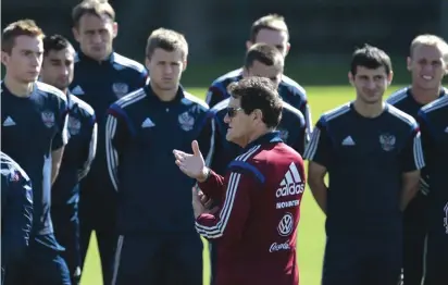  ?? Photo: AP ?? Fabio Capello, Italian coach of the Russian national team, centre, speaks to his players during a training session