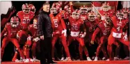  ?? AP FILE PHOTO BY RICK BOWMER ?? In this Nov. 24, 2018, file photo, Utah head coach Kyle Whittingha­m and his team prepares to take the field prior to their game against the BYU during an NCAA college football game, in Salt Lake City.