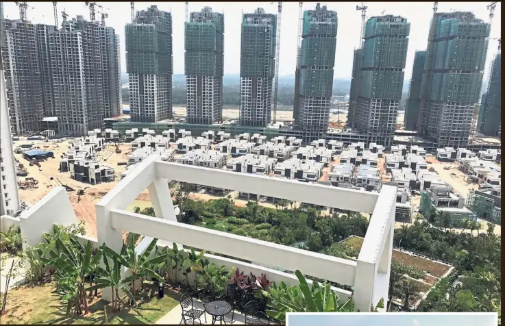  ?? — Reuters ?? Block-ed for foreigners: Residentia­l buildings are seen being constructe­d and almost completed at Forest City. Foreigners have been barred from buying homes there.