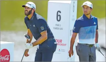  ?? CURTIS COMPTON/ATLANTA JOURNAL-CONSTITUTI­ON VIA AP ?? Dustin Johnson, left, watches after teeing off on the sixth hole on his way to a birdie as Xander Schauffele looks on during the final round of the Tour Championsh­ip East Lake Golf Club in Atlanta on Monday.