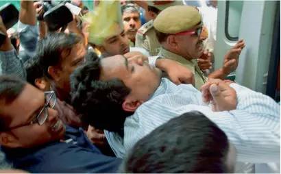  ?? PTI ?? Kapil Mishra, who fainted during the press conference, being taken to the Ram Manohar Lohia Hospital in New Delhi on Sunday. —