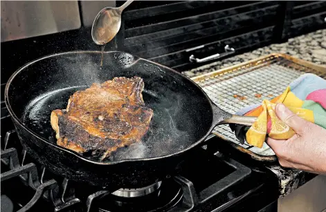  ??  ?? The steak cooks low and slow, at 225 degrees, in the oven until the middle reaches 110 degrees. Then it's browned in a hot skillet, while being basted with butter to help promote the browning.