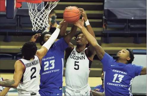  ?? David Butler II / USA TODAY ?? UConn’s Isaiah Whaley (5) and James Bouknight (2) battle for a rebound against Central Connecticu­t State’s Karrington Wallace (23) and guard Jamir Reed (13) last month.