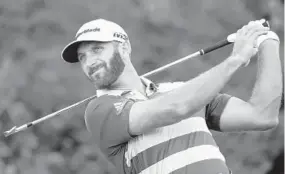  ?? SETH WENIG/ASSOCIATED PRESS ?? Dustin Johnson of the United States plays his shot from the 15th tee on his way to a 77 that left him in a four-way tie for first place.