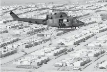  ??  ?? A Canadian Forces Griffon helicopter flies over a displaced-persons camp near Erbil, Iraq, on Monday.