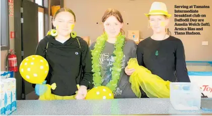  ?? ?? Serving at Tamatea Intermedia­te breakfast club on Daffodil Day are Amelia Welch (left), Arnica Blas and Tiana Hudson.