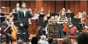  ??  ?? Playing for peace: Soltani (left) with his 1680 cello by the brothers Giovanni and Francesco Grancino, and Manasherov (right) standing after playing solos in ‘Don Quixote’ at Washington, DC. — AFP