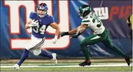  ?? Adam Hunger / Associated Press ?? New York Giants running back Sandro Platzgumme­r rushes past New York Jets defensive back Sharrod Neasman during a preseason game on Saturday.