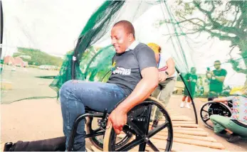  ?? ?? uMhlabuyal­ingana Mayor Thembinkos­i Khumalo trying out the disabled track at the Manguzi Gijima games