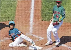  ?? GENE J. PUSKAR/THE ASSOCIATED PRESS ?? Venezuela’s Jhann Bozo scores from third on a wild pitch by Mexico pitcher Jorge Garcia, right, in their game last Thursday in Williamspo­rt, Pa. Venezuela beat the Dominican Republic on Monday and will play a rematch against Mexico on Tuesday.