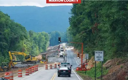 ?? STAFF PHOTO BY TIM BARBER ?? Southbound traffic gets the green light after a 5-minute wait on U.S. 41, in the Tennessee River Gorge on Wednesday entering the one mile stretch of road where workers were removing guard railing and supports from the original roadway.