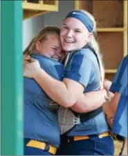  ?? AUSTIN HERTZOG - DIGITAL FIRST MEDIA ?? Upper Perkiomen’s Kelsey Bernhart, left, gets a hug from catcher Morgan Lindsay after hitting a home run in the second inning against Nanticoke during a PIAA 4A first round game Monday at Methacton.