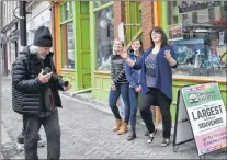  ?? MELISSA WONG/SPECIAL TO THE TELEGRAM ?? Downhome Shoppe and Gallery staff (from right) manager Jackie Rice, Ciara Hodge and Megan Thomey, share a laugh with Tod (George) Slone outside the shop on Water Street in St. John’s. Slone is a writer and photograph­er who had just interviewe­d them.