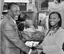  ?? PHOTOS BY CARL GILCHRIST ?? Angella Campbell-Treasure collects her award from Councillor Delroy Kelly.