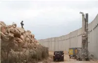  ?? (IDF) ?? A SOLDIER stands watch over the engineerin­g machine looking for Hezbollah tunnels near the border with Lebanon yesterday.