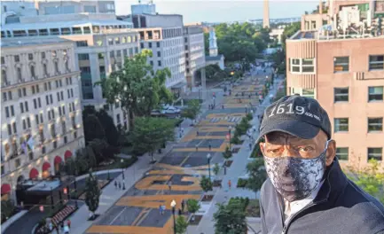  ?? KHALID NAJI-ALLAH/EXECUTIVE OFFICE OF THE MAYOR VIA AP ?? Rep. John Lewis, wearing a 1619 hat marking the start of U.S. slavery, looks over the Black Lives Matter Plaza in Washington, D.C., last month.