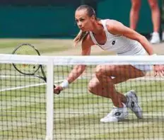  ?? AFP ?? Rybarikova plays a volley at the net against Muguruza during their singles semi-finals yesterday. Muguruza won 6-1, 6-1.