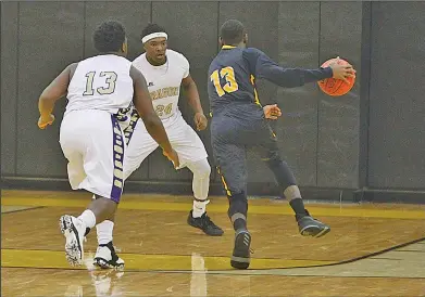  ?? Terrance Armstard/News-Times ?? Dragons' lair: Junction City's Hishmma Taylor and Terrell Gibson defend against a Harmony Grove player as he drives toward the basket. The Dragons take on Harding Academy today at 2:30 p.m. in the 3A State Tournament, hosted by Drew Central in...