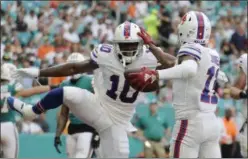  ?? LYNNE SLADKY ?? Buffalo Bills wide receiver Deonte Thompson (10) celebrates with wide receiver Zay Jones (11) after Jones scored a touchdown, during the first half of an NFL football game against the Miami Dolphins, Sunday.