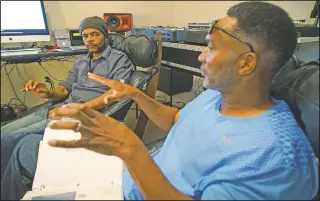  ?? (AP/Allen G. Breed) ?? Musician Youtha Anthony Fowler (left), known as DJ Nabs, listens to lifelong best friend Alton Lucas talk about his drug addiction in Nabs’ home studio outside of Raleigh, N.C. By their teen years, Lucas and Fowler were deejaying for college parties at nearby Duke University. Together, “Luke Duke,” as Lucas was known, and “Nabisco Disco,” as Fowler was called, helped popularize hip-hop music among undergradu­ates.