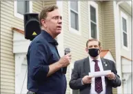  ?? Erik Trautmann / Hearst Connecticu­t Media ?? Gov. Ned Lamont speaks at a Greenwich Communitie­s plaque dedication at its Armstrong Court affordable housing apartment complex on Saturday. Sam Romeo, chairman of Greenwich Communitie­s’ Board of Commission­ers, is in the background.
