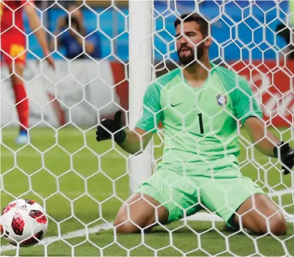  ??  ?? Brazil goalkeeper Alisson, centre, fails to stop Belgium’s first goal during the quarterfin­al match between Brazil and Belgium Photo: AP