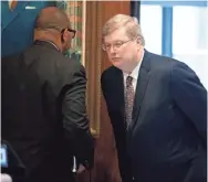  ?? MAX GERSH/THE COMMERCIAL APPEAL ?? Keith Norman, vice president of government affairs for Baptist Memorial Health Care, whispers to Memphis Mayor Jim Strickland on Monday during a press conference at City Hall in downtown Memphis.