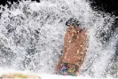  ?? Suzanne Cordeiro/AFP/Getty Images ?? A boy cools off in a swimming pool at Barton Creek as extreme temperatur­es across Texas affect more than 40 million people in Austin, on 27 June. Photograph: