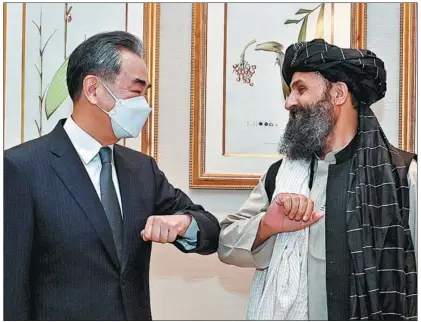  ?? XINHUA ?? State Councilor and Foreign Minister Wang Yi meets Mullah Abdul Ghani Baradar, acting deputy prime minister in the interim Afghan government, in Doha, Qatar, on Oct 25.