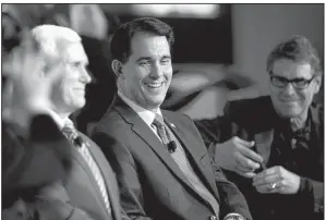  ?? AP ?? Wisconsin Gov. Scott Walker (center) is flanked by Indiana Gov. Mike Pence (left) and Texas Gov. Rick Perry at the Nov. 19 Republican Governors Associatio­n’s annual conference in Boca Raton, Fla. All three are considered possible presidenti­al...