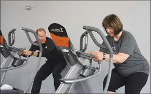  ?? NEWS PHOTO MO CRANKER ?? Classic Loser trainer Todd Schneider works out with contestant Celeste Coderre Saturday at the Caloric Responsibi­lity gym. Coderre has lost 17 pounds through the first six weeks of the contest, with a goal of losing 17 more.