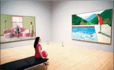  ?? NEIL HALL / REUTERS ?? A woman looks at a work titled Pool with two figures by David Hockney during an exhibition at the Tate Britain in London.