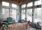  ?? ?? The sunroom features multiple windows, a wood ceiling and a view of the river.