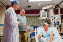  ?? AP ?? Andy Sandness (right) talks with his father, Reed Sandness, and Dr Samir Mardini (left) before Andy’s face transplant procedure at the Mayo Clinic in Rochester, Minnesota where he got a new life.