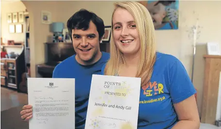  ?? Picture: Kim Cessford. ?? Andy and Jennifer Gill at home with their letter from the Prime Minister and certificat­e from Points of Light.