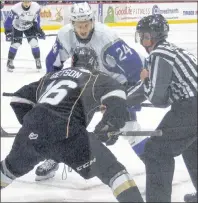  ?? CHARLES REID/THE GUARDIAN ?? Cedric Parre (24) of the Saint John Sea Dogs faces off against Keith Getson of the Charlottet­own Islanders in Quebec Major Junior Hockey League action Thursday in Charlottet­own. The Isles won 3-2.