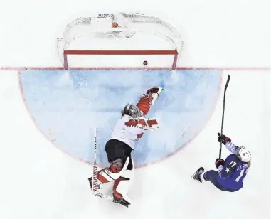  ?? ANDREW NELLES/ USA TODAY SPORTS ?? U.S. forward Jocelyne Lamoureux scores past Canada goaltender Shannon Szabados during the sixth round of the shootout in the women’s hockey gold medal game.